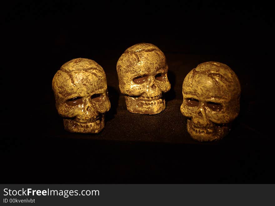 Halloween image - 3 dimly lit skulls isolated on black background. Halloween image - 3 dimly lit skulls isolated on black background