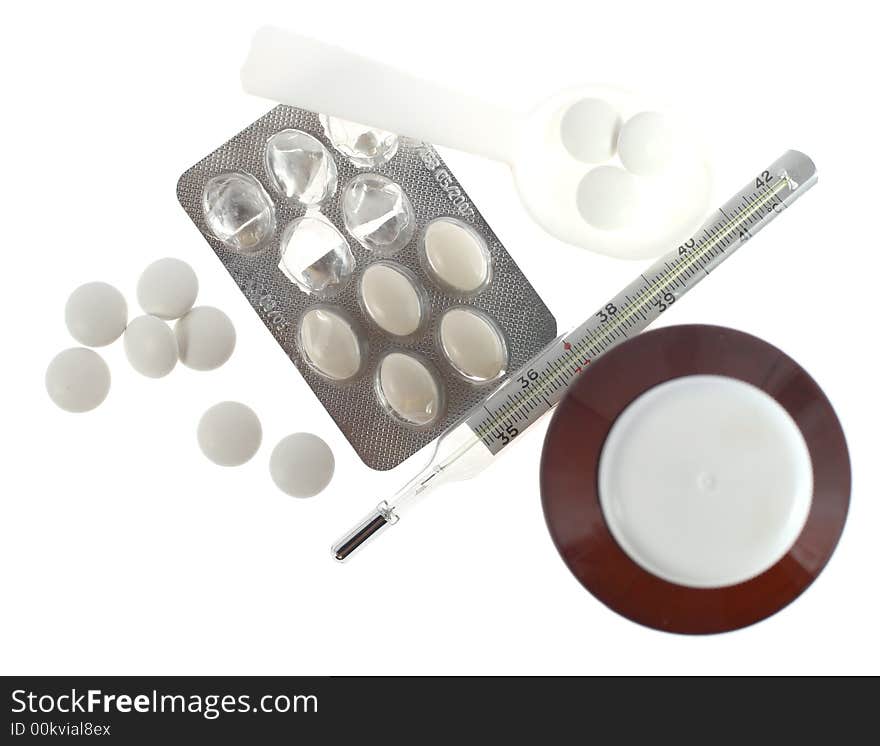 Medications pills, thermometer and other on white