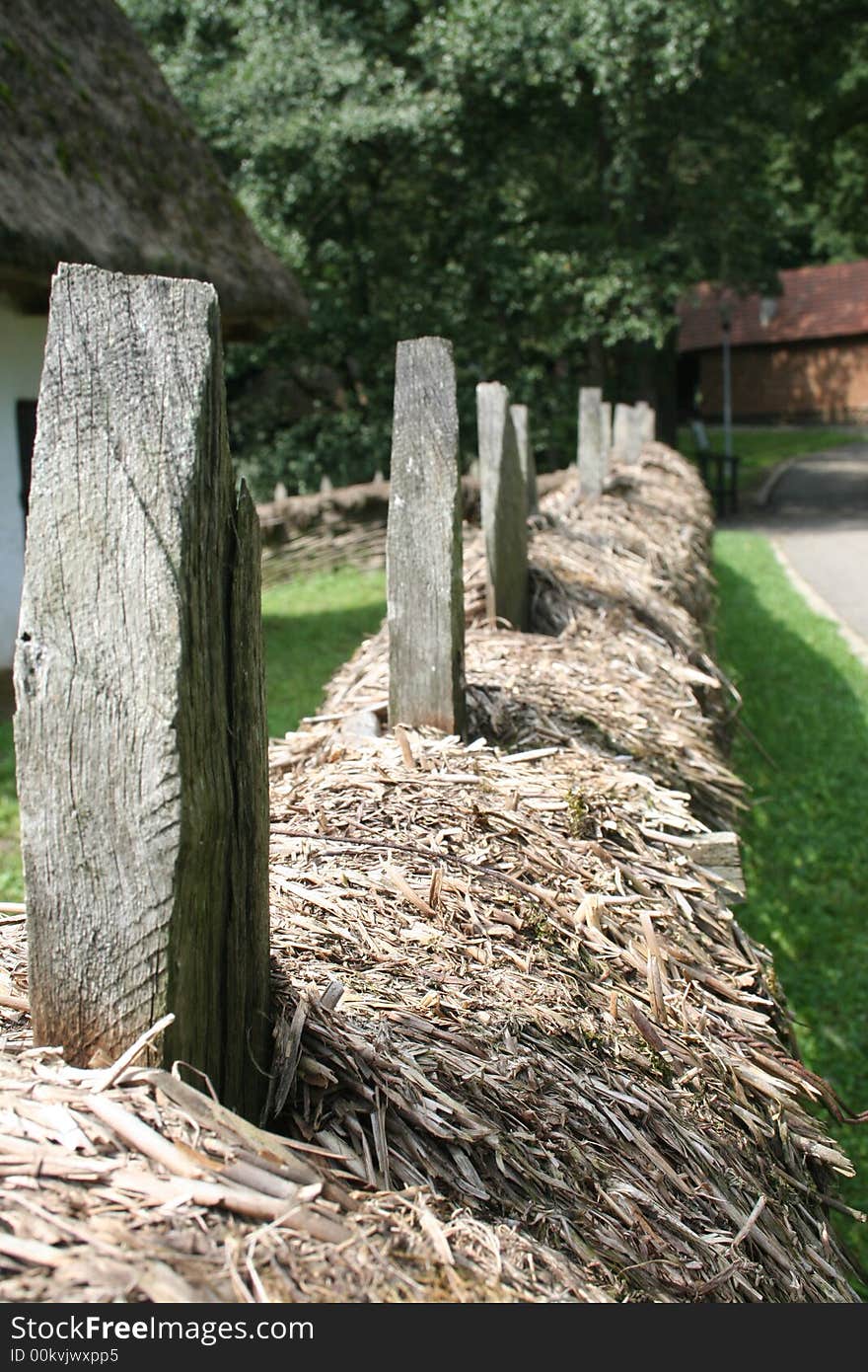 Details of an ancient wooden fence covered with hay. Details of an ancient wooden fence covered with hay