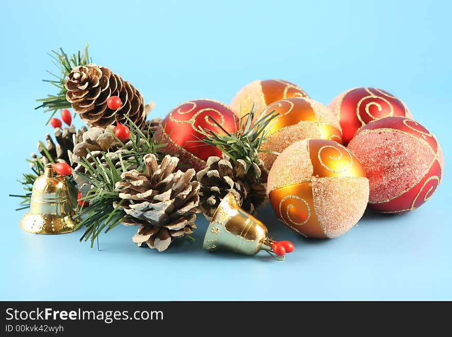 Christmas cones, balls and handbells on a blue background. Christmas cones, balls and handbells on a blue background.