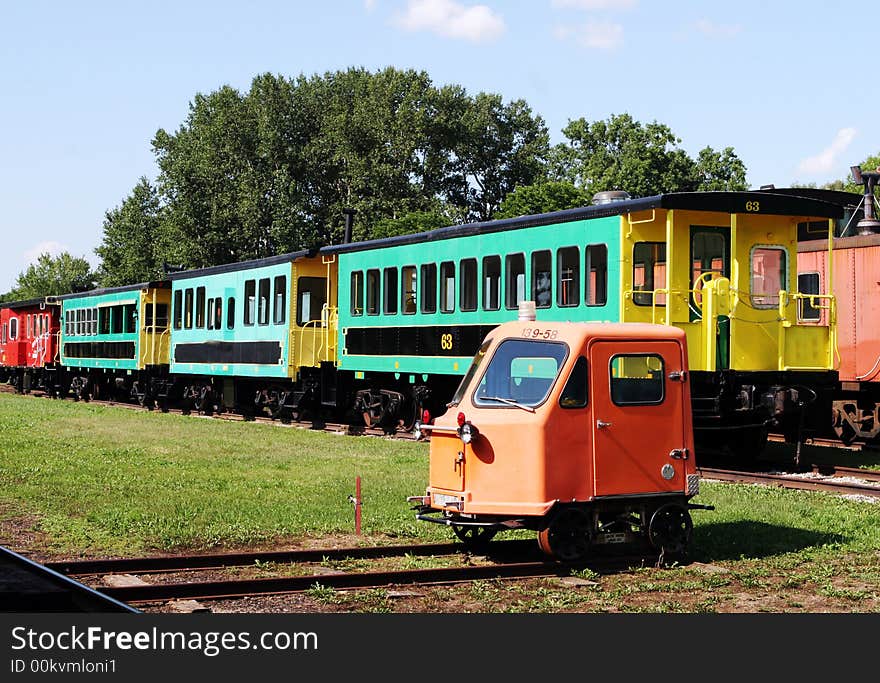 Colorful train carriages at a railway station. Colorful train carriages at a railway station.