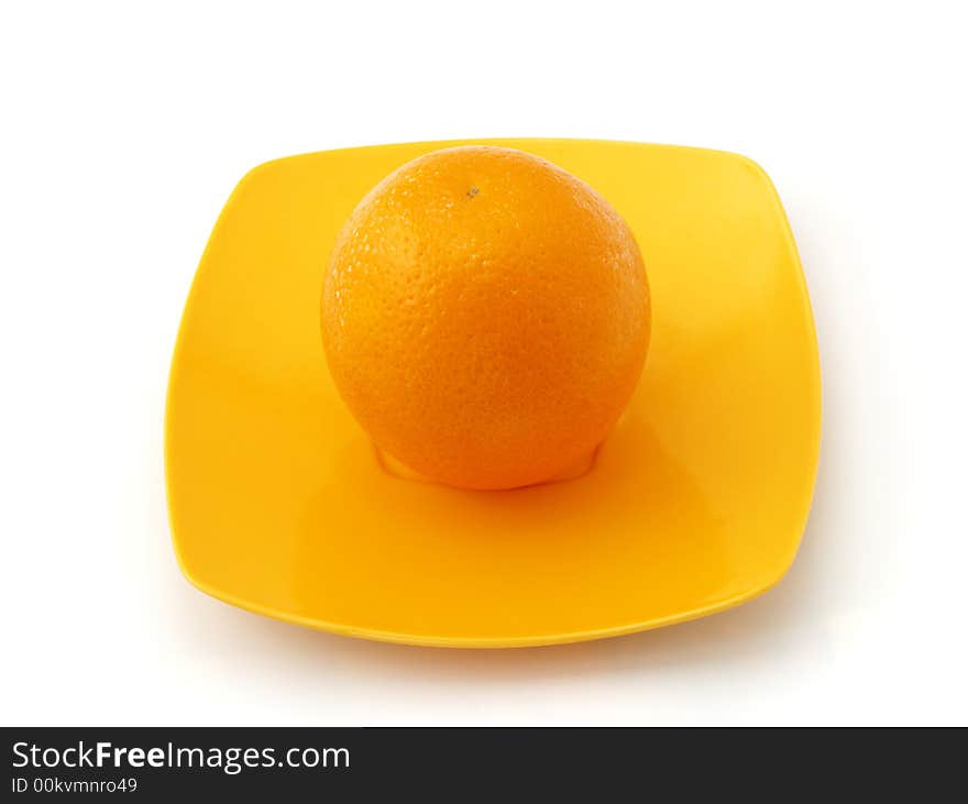 Orange on the colorful saucer isolated on white background. Orange on the colorful saucer isolated on white background