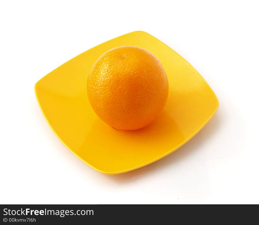 Orange on the colorful saucer isolated on white background. Orange on the colorful saucer isolated on white background