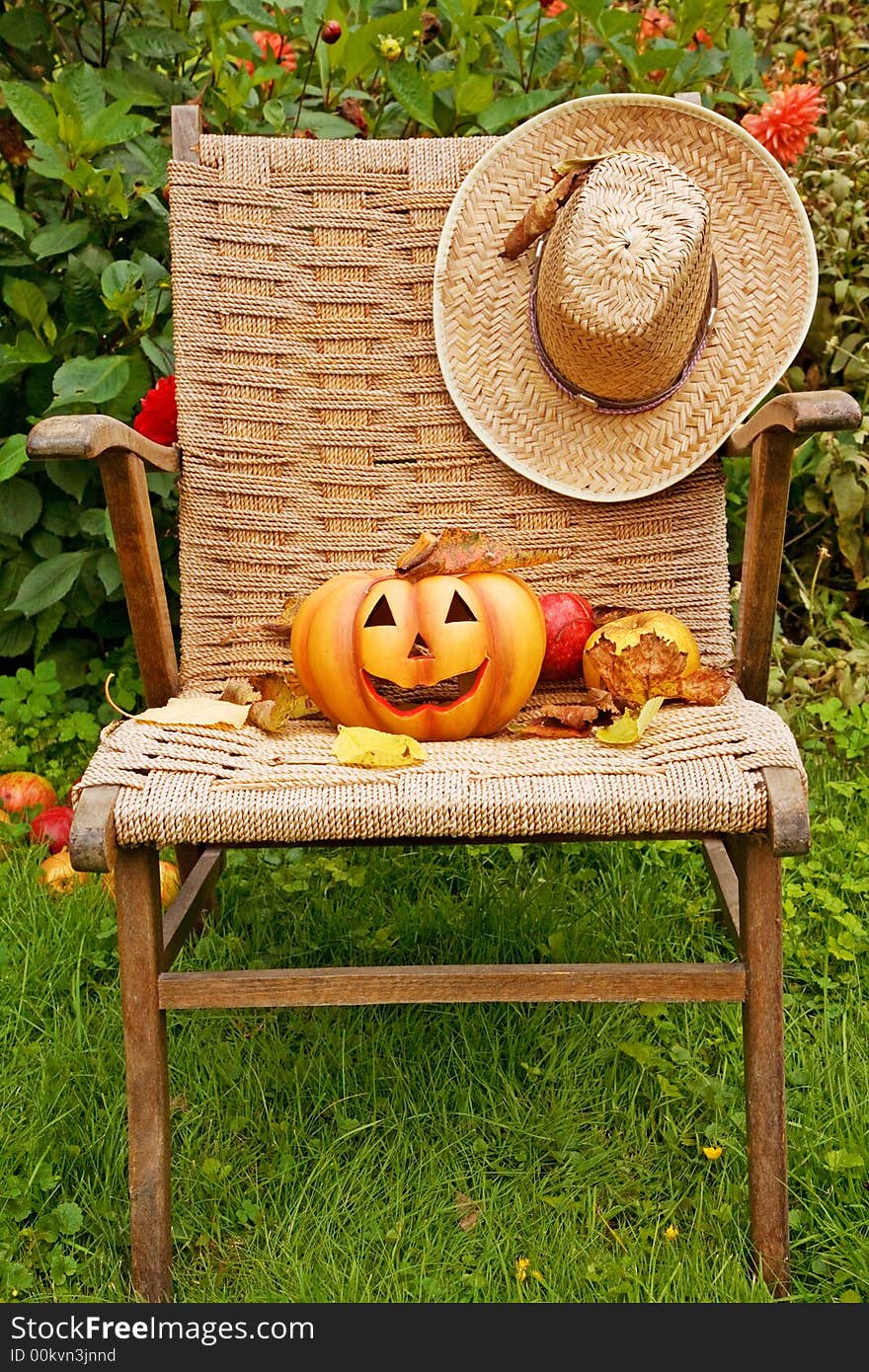 Halloween pumpkin with straw hat, fruit and leaves. Halloween pumpkin with straw hat, fruit and leaves.