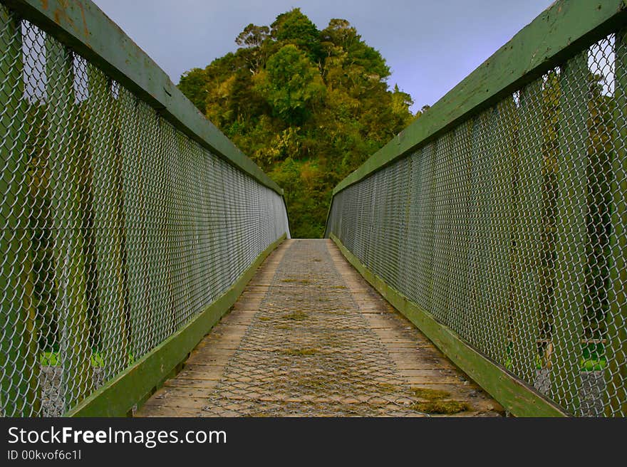 Crossing a wire bridge leading into the bush