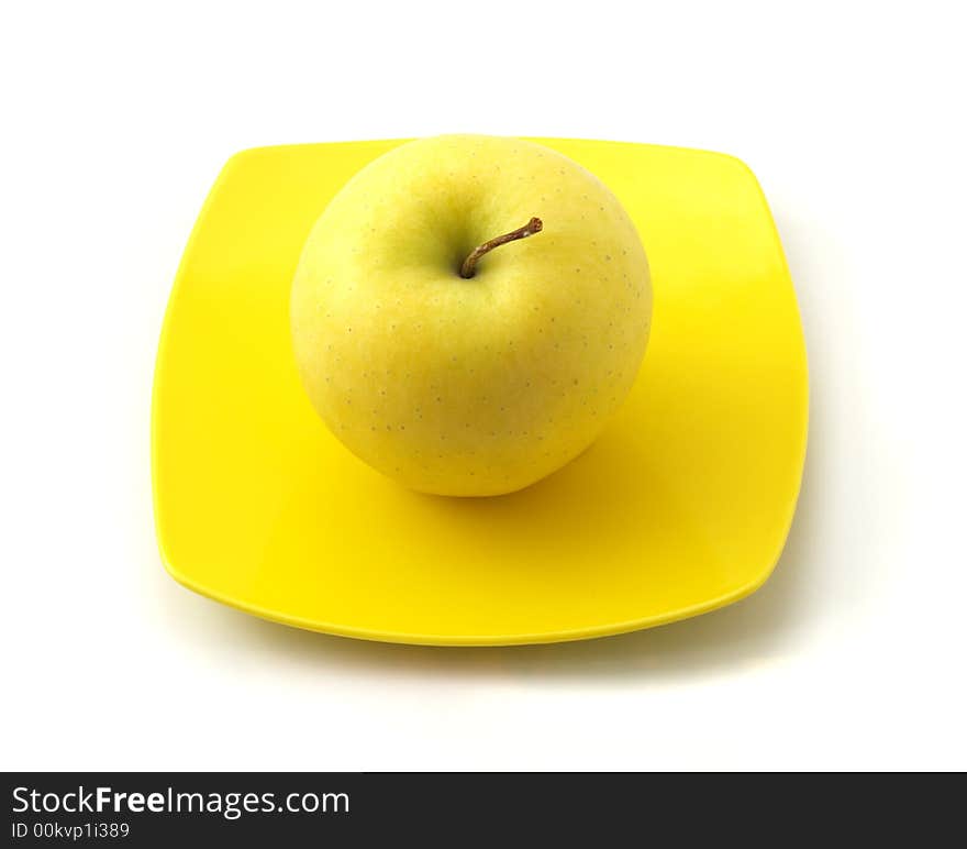 Yellow apple on the dish