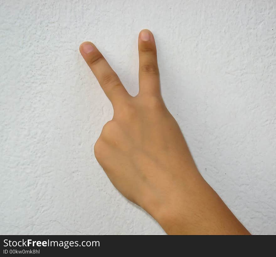 A female hand making the sign of victory