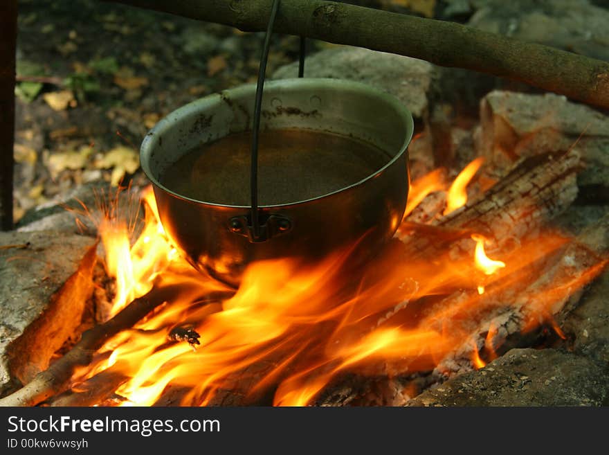 Saucepan on fire. Cooking in a wood