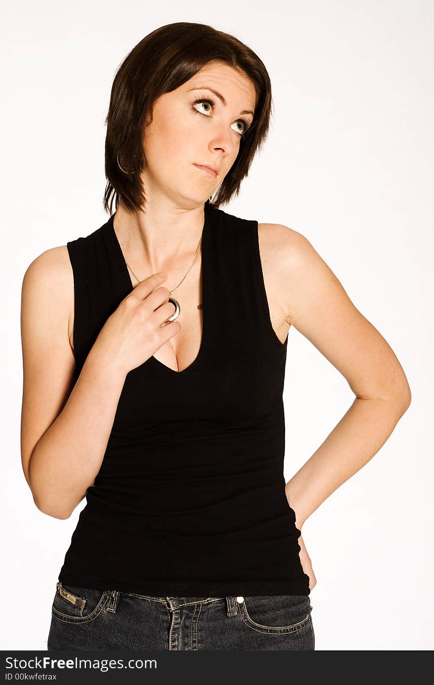 Beautiful brunette girl in black shirt posing on light background