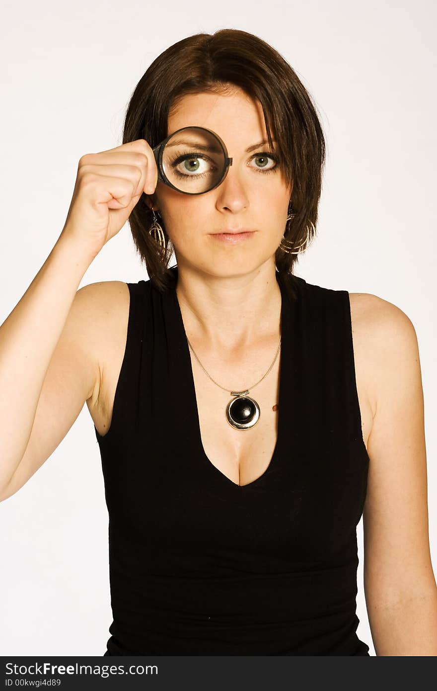 Beautiful brunette girl in black shirt posing on light background