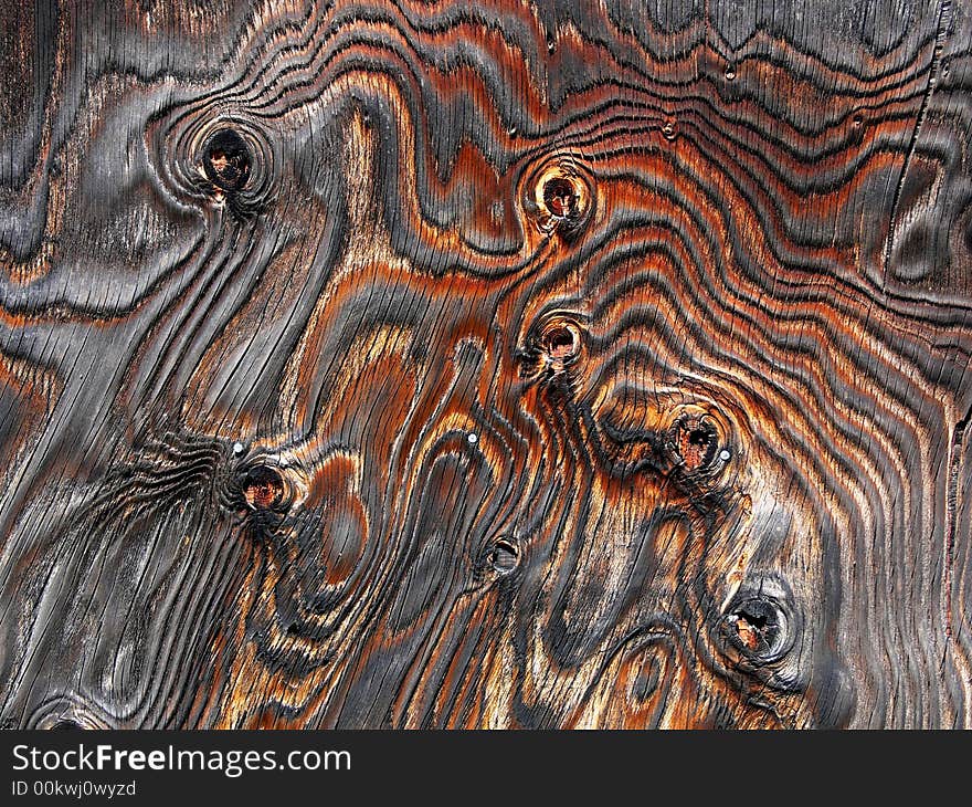 Shot of a plywood wall with knots and unusual grain patterns. Shot of a plywood wall with knots and unusual grain patterns.