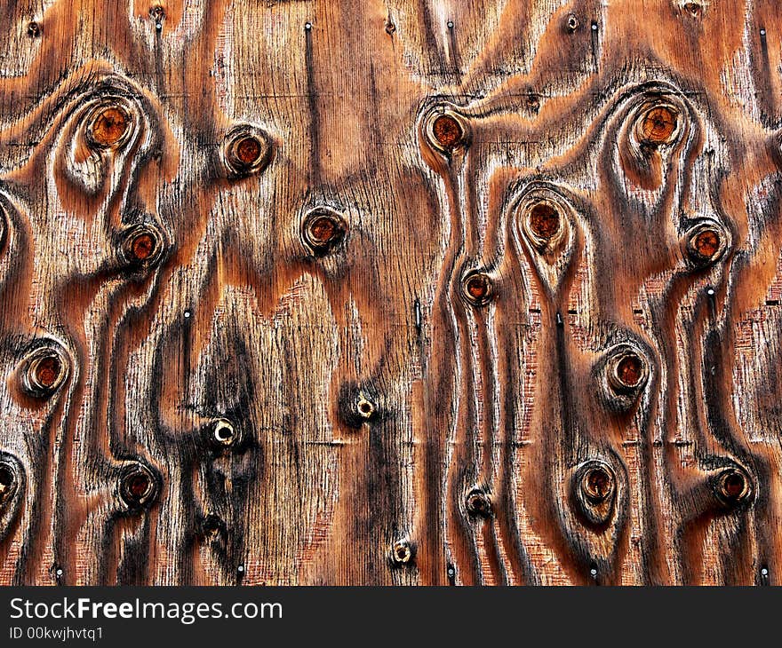 Shot of a plywood panel with knots and unusual wood grains and patterns. Shot of a plywood panel with knots and unusual wood grains and patterns.