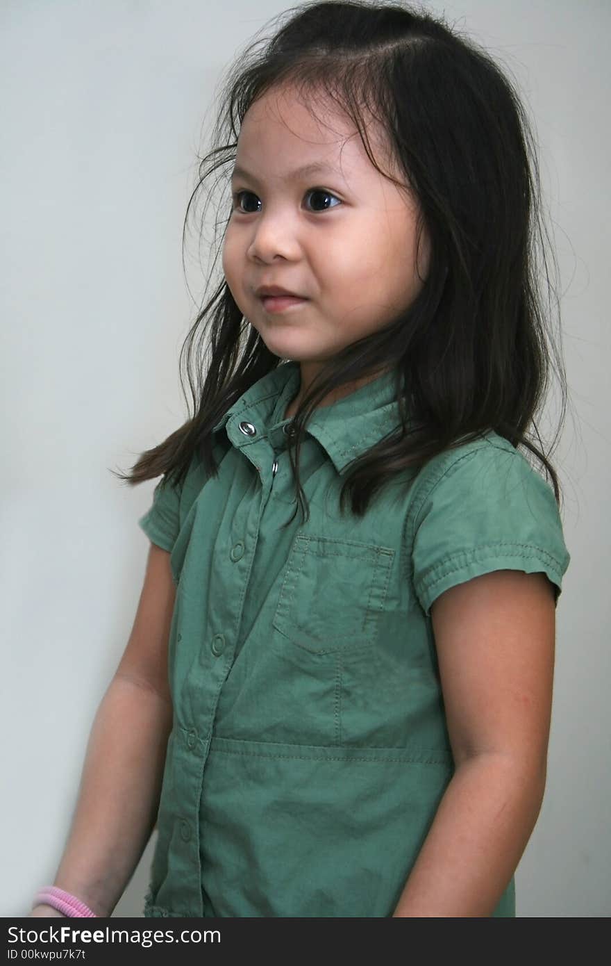 Little girl in green skirt looking joyfully. Little girl in green skirt looking joyfully