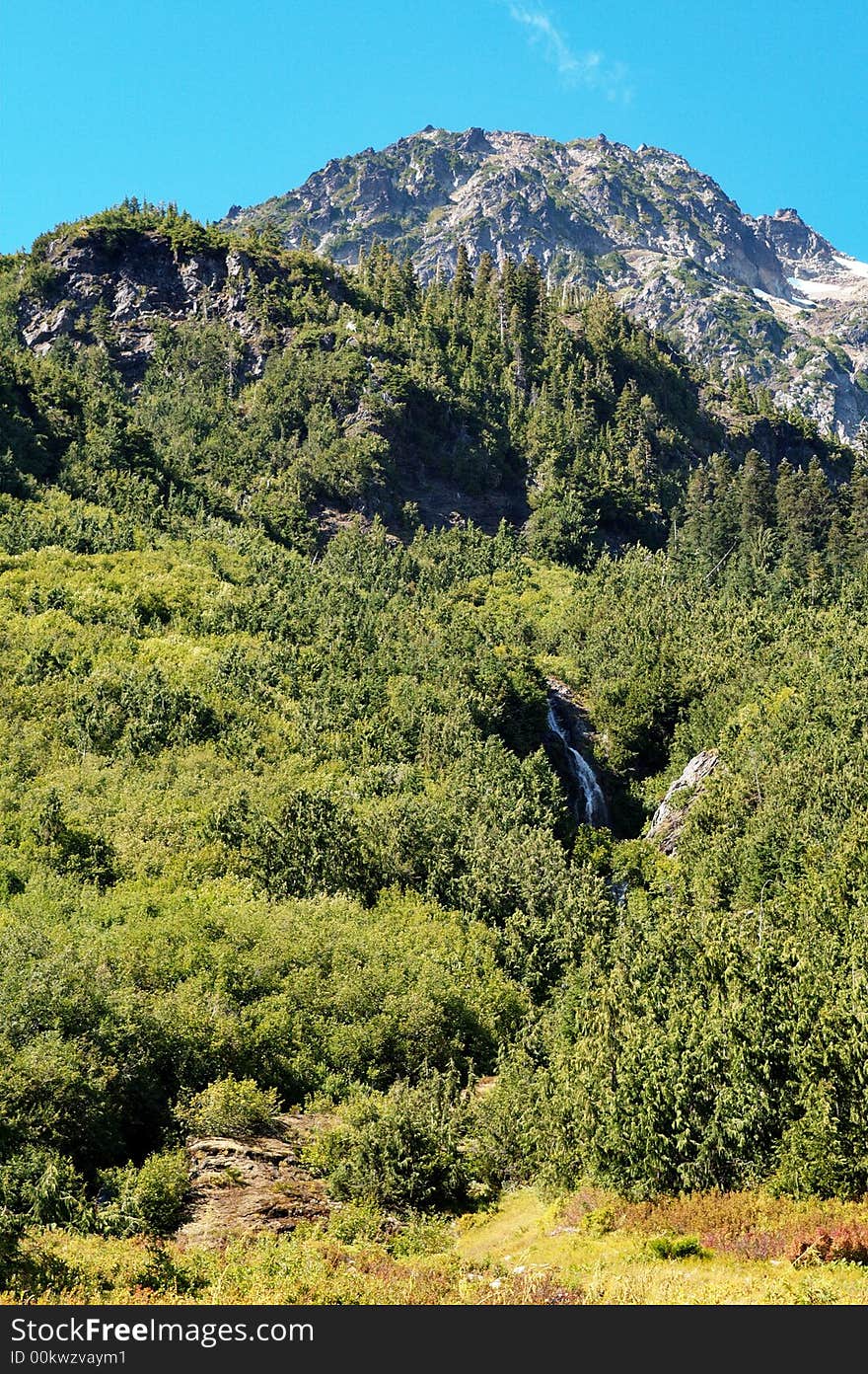 A waterfall on the side of a mountain in the Olympic National Park near Anderson Pass. A waterfall on the side of a mountain in the Olympic National Park near Anderson Pass.