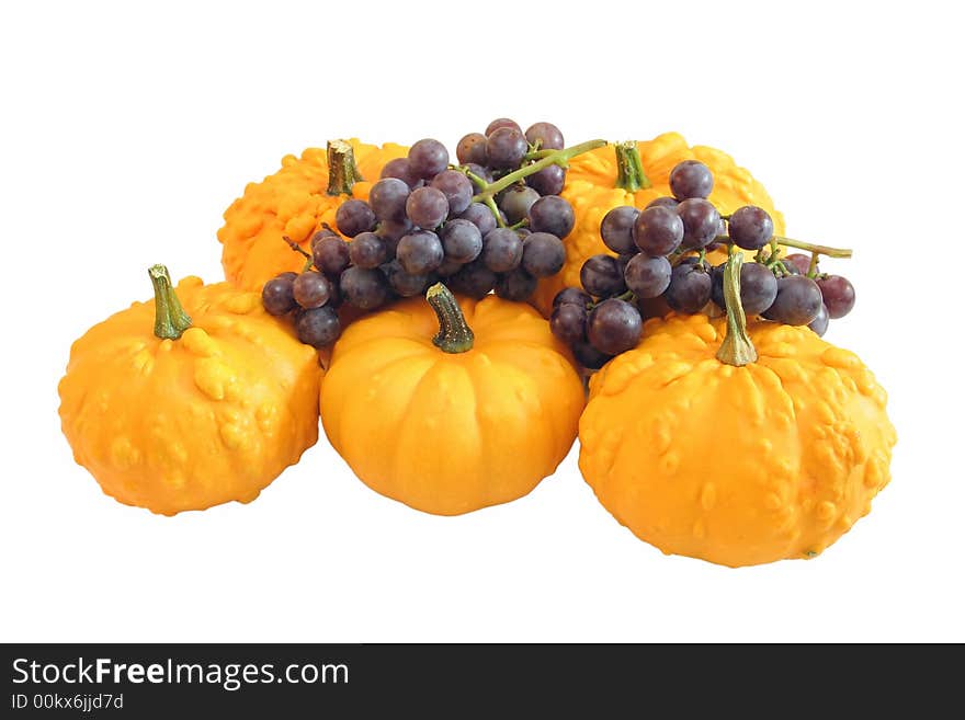 Ornamental squash and grapes on white