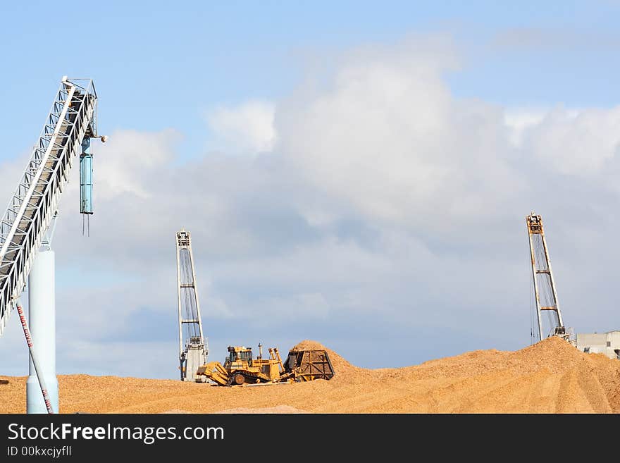 Large earthmover with scoop of wood chips. Large earthmover with scoop of wood chips