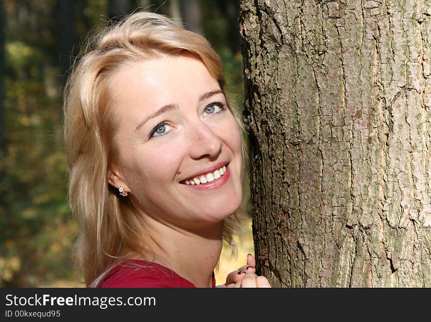 The beautiful girl with leaves of a maple