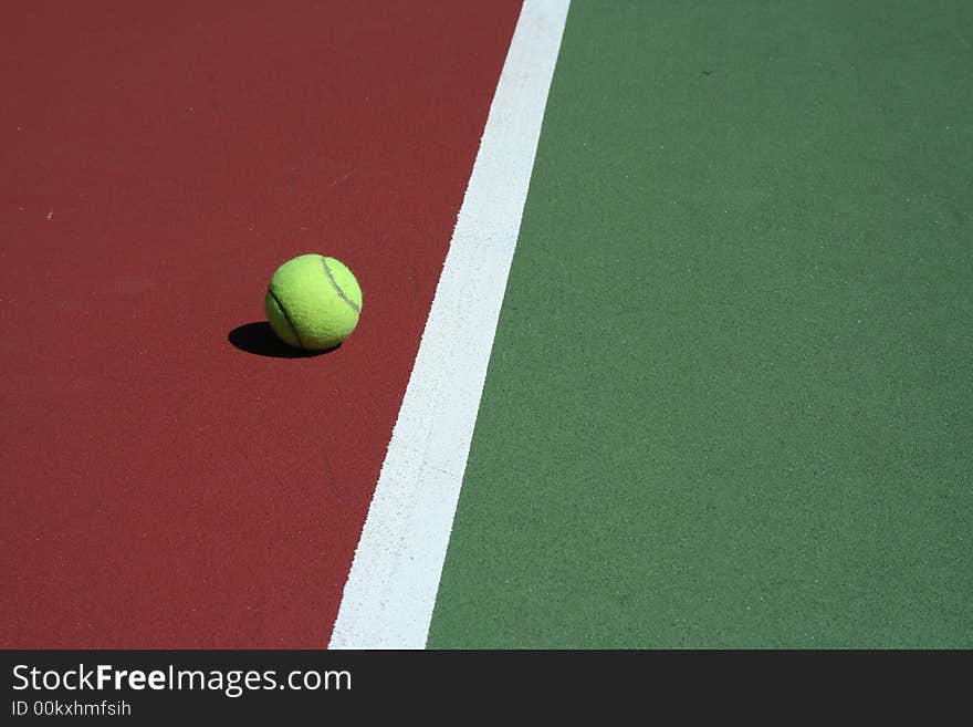 A Tennis Ball out of bounds with white line