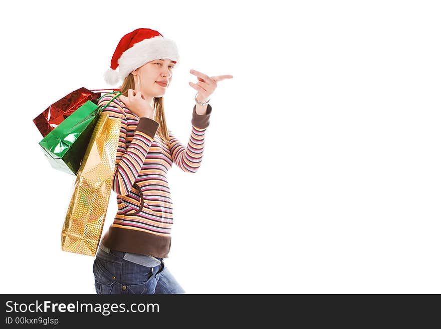 Young  christmas girl in red hat with package show finger. Young  christmas girl in red hat with package show finger