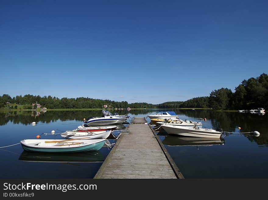 Boats docked in the swedish skargarden during daytime. Boats docked in the swedish skargarden during daytime