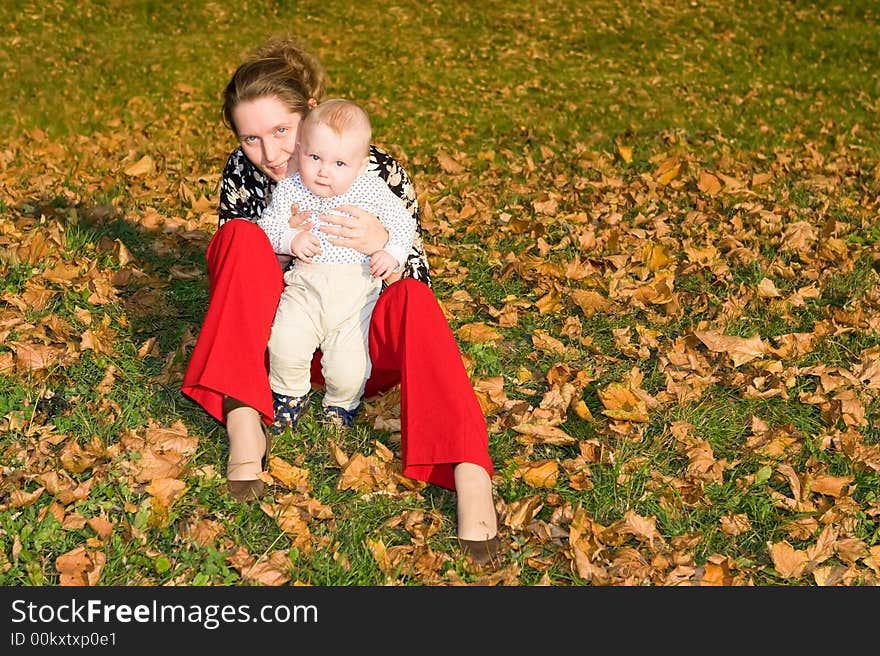 Little child embraces mother and looks out at her shoulder. Little child embraces mother and looks out at her shoulder