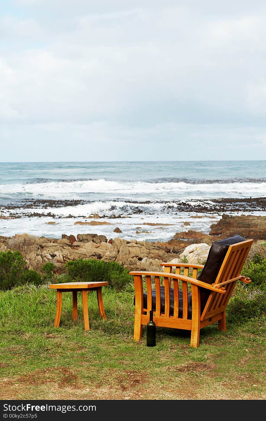 Wooden chair standing outside by the ocean. Perfect leisure scene