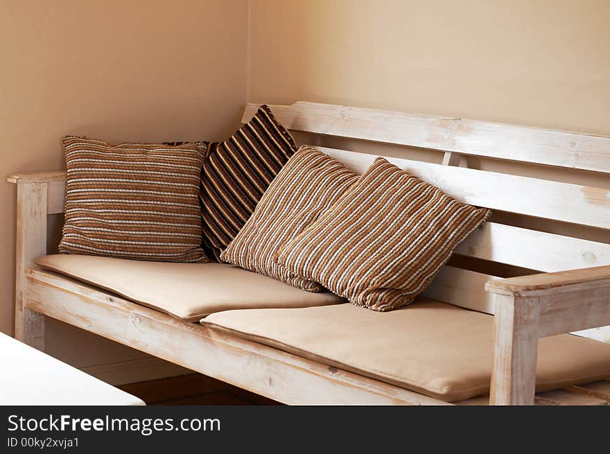 Wooden couch with cushions