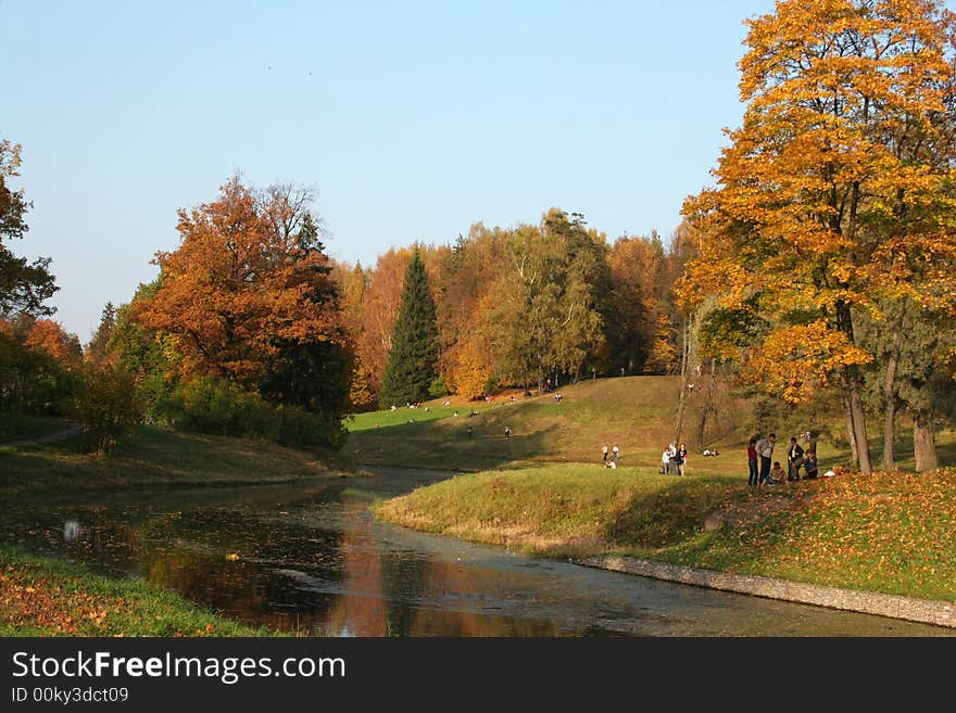 Picturesque autumn landscape of river and bright trees and bushes