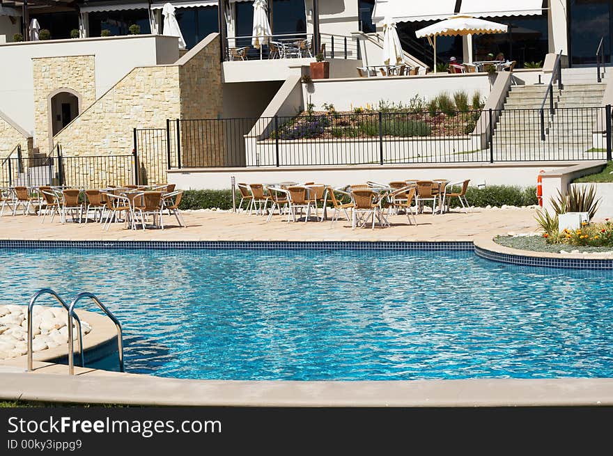 Swimming pool infront of expensive building on a summer day