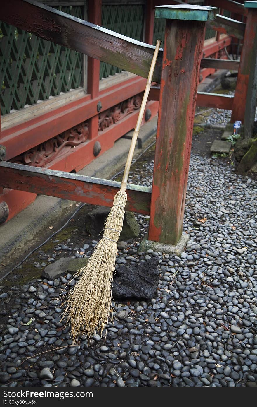 A broom rests on a porch in japan. A broom rests on a porch in japan