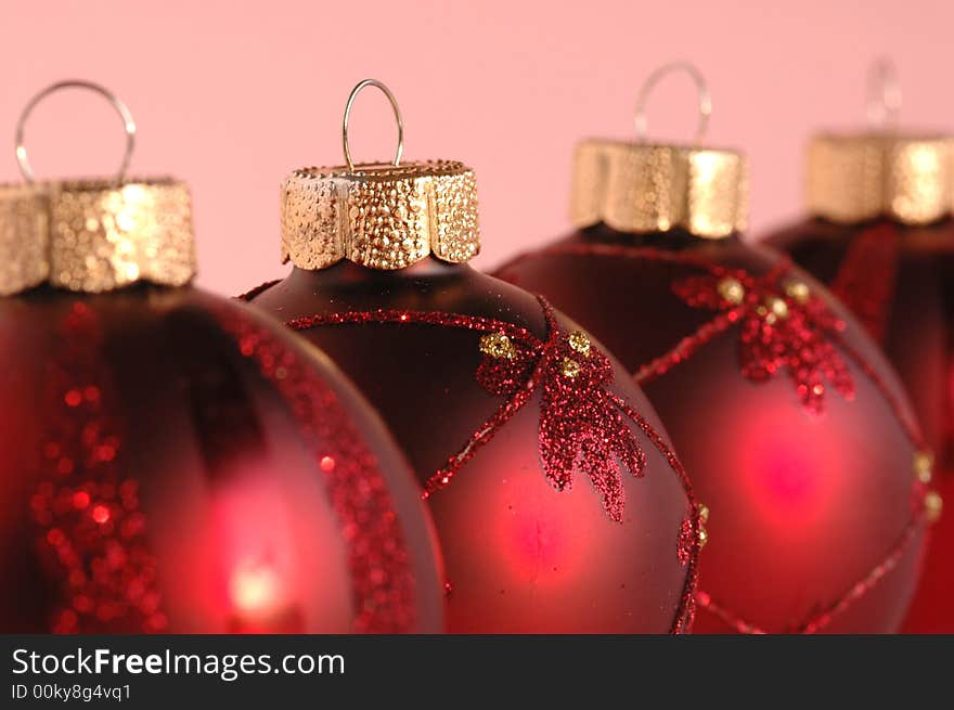 Red christmas decoration balls against pink background