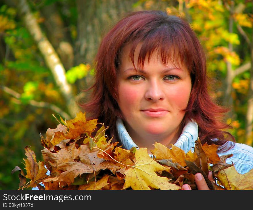 Woman with autumn leaves