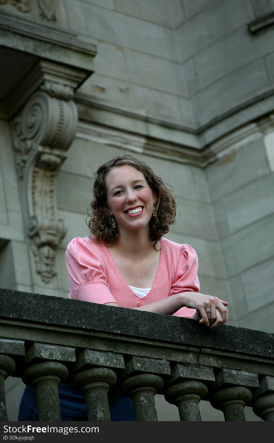 Image of a teenage girl on the balcony of an old building