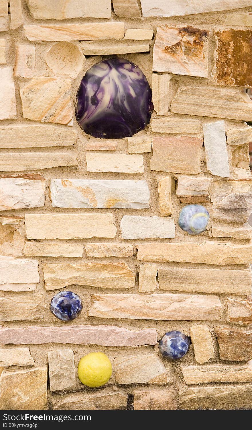 A stone wall with balls embedded useful for a background. A stone wall with balls embedded useful for a background