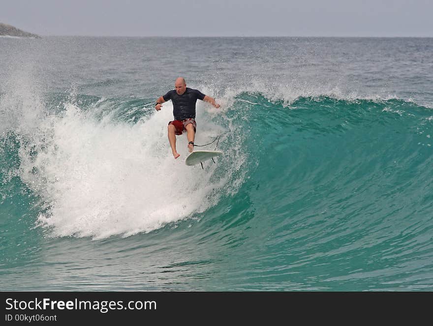 A surfer gets his take off wrong and wipes out. A surfer gets his take off wrong and wipes out