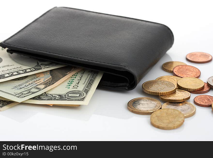 A few dollar bills inside a leather wallet. A few dollar bills inside a leather wallet