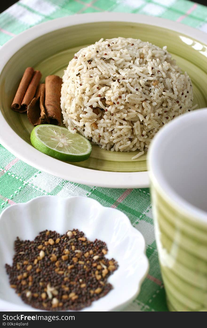 Asian exotic spiced rice served in a green earthenware plate set. Asian exotic spiced rice served in a green earthenware plate set