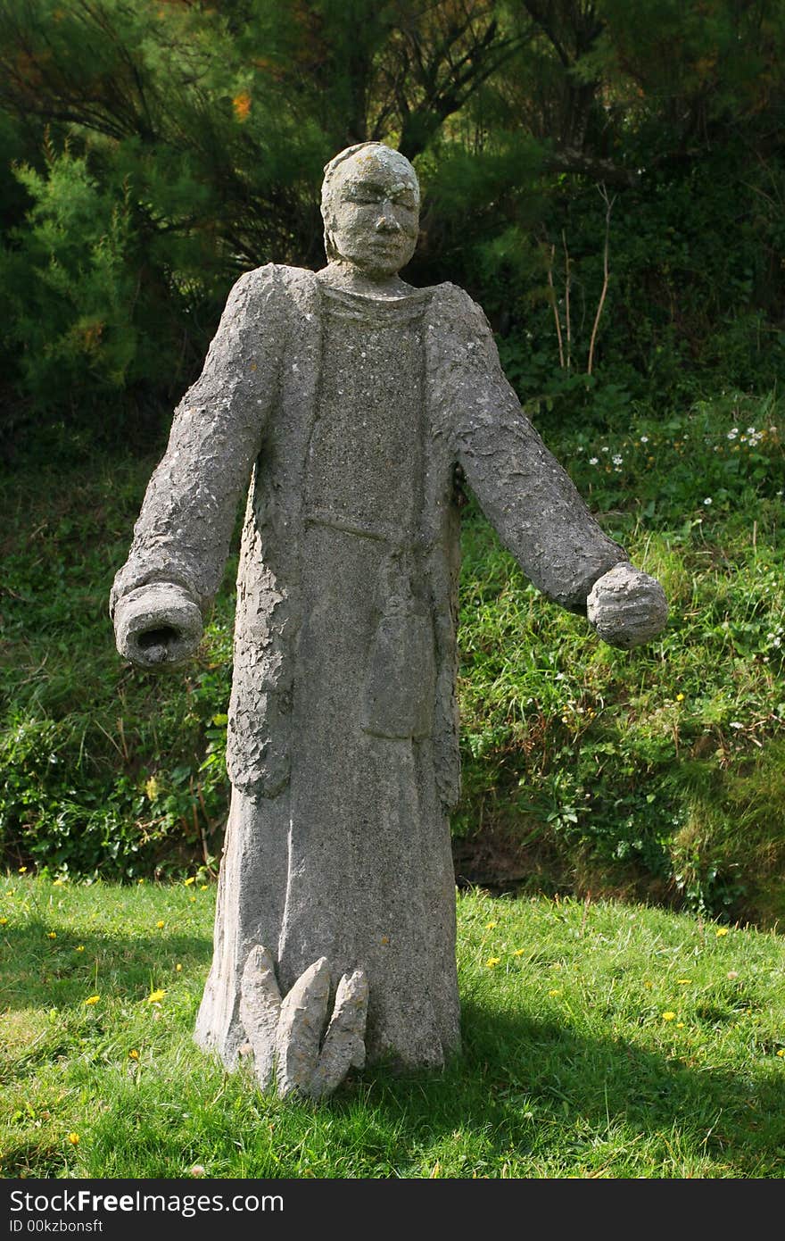 A stone statue of a monk. A stone statue of a monk