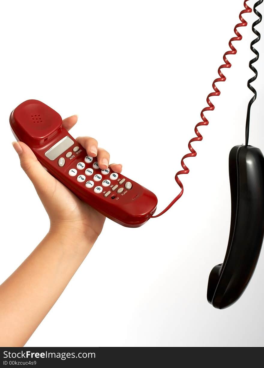 Handset phones hanging over a white background. Handset phones hanging over a white background