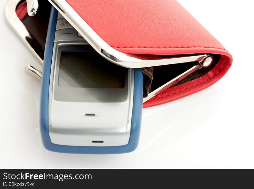 A mobile phone inside a red wallet over a white background. A mobile phone inside a red wallet over a white background