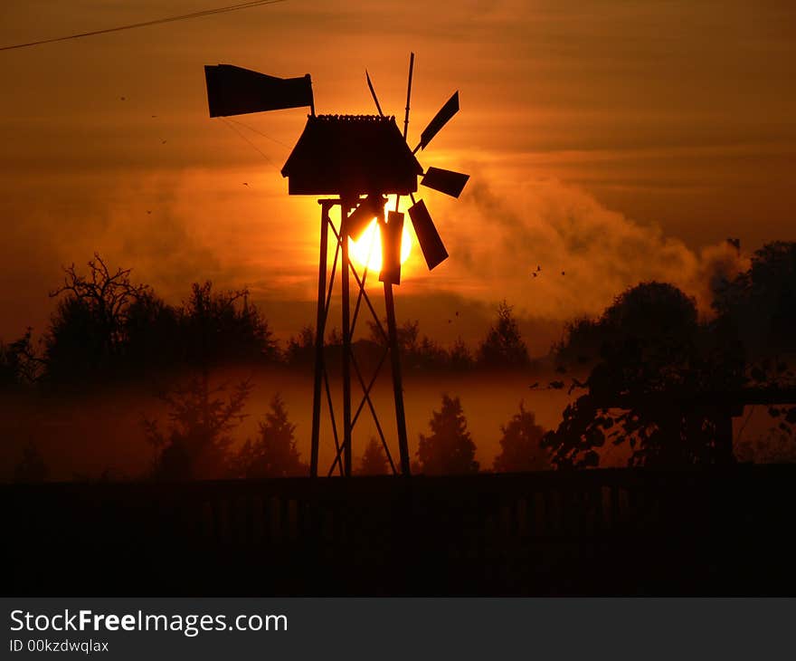 Windmill in sun in field. Windmill in sun in field