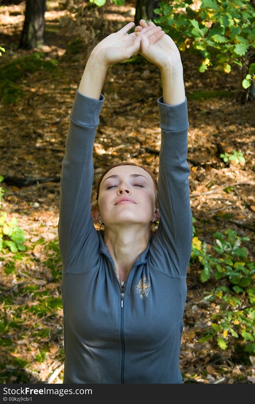 A youg attractive woman is relaxing in autumn forest. A youg attractive woman is relaxing in autumn forest