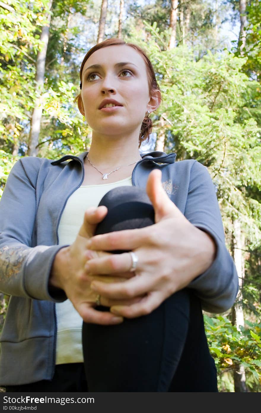 A youg attractive woman is relaxing in autumn forest. A youg attractive woman is relaxing in autumn forest