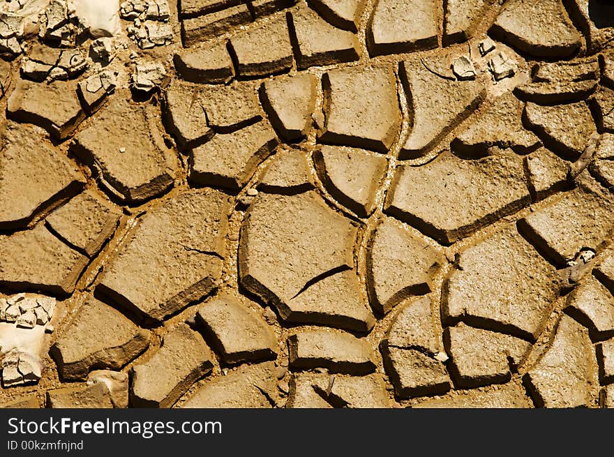 Dried soil cracking under the scorching sun. Dried soil cracking under the scorching sun