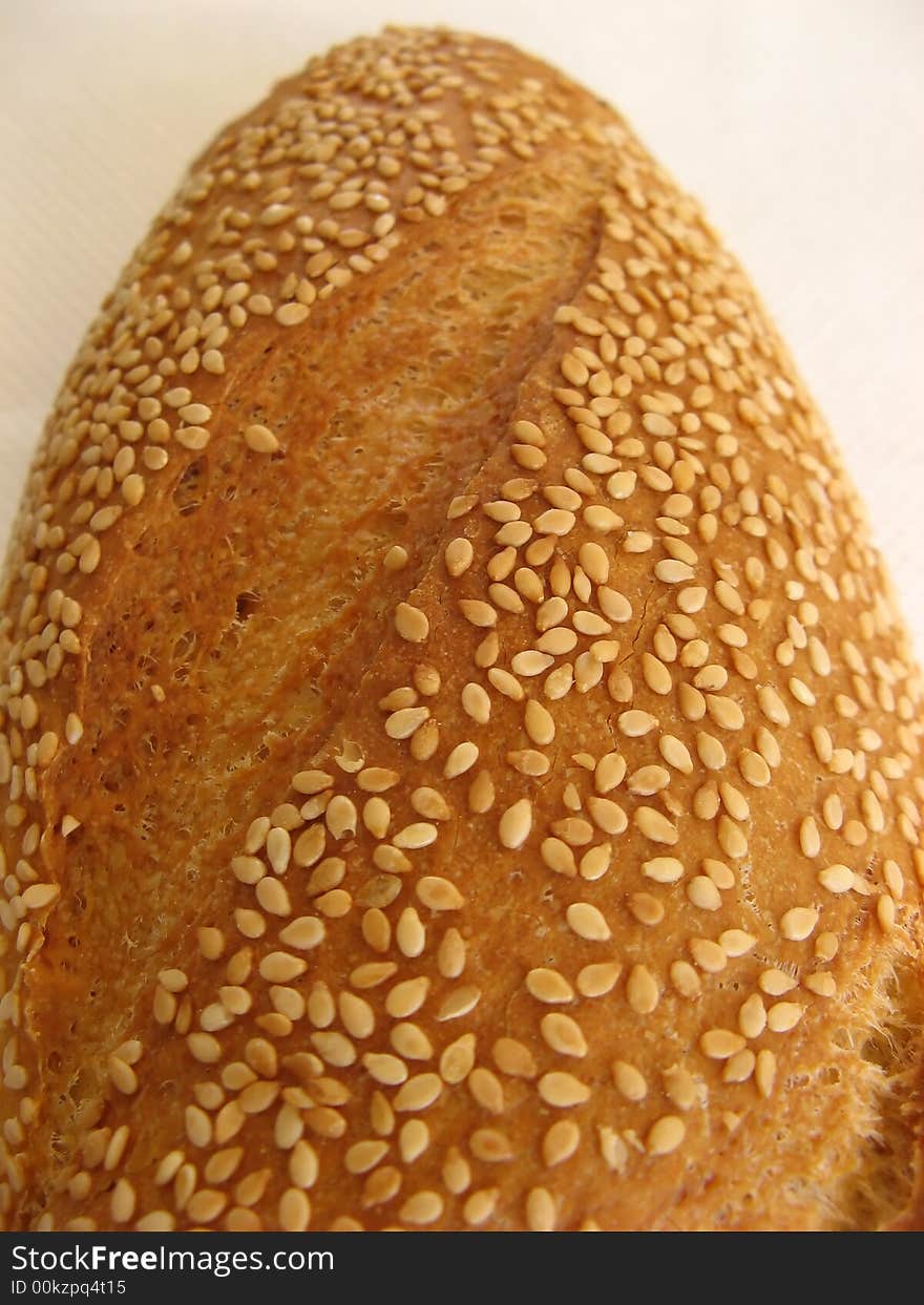 Piece of daily bread with sesame. Isolated