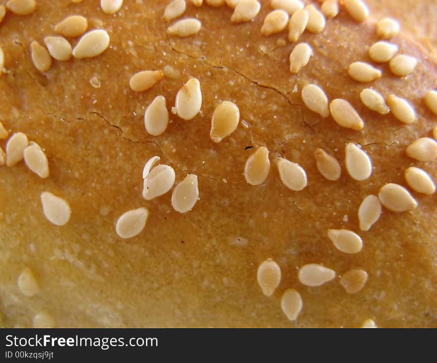 Piece of daily bread with sesame. Isolated on white background