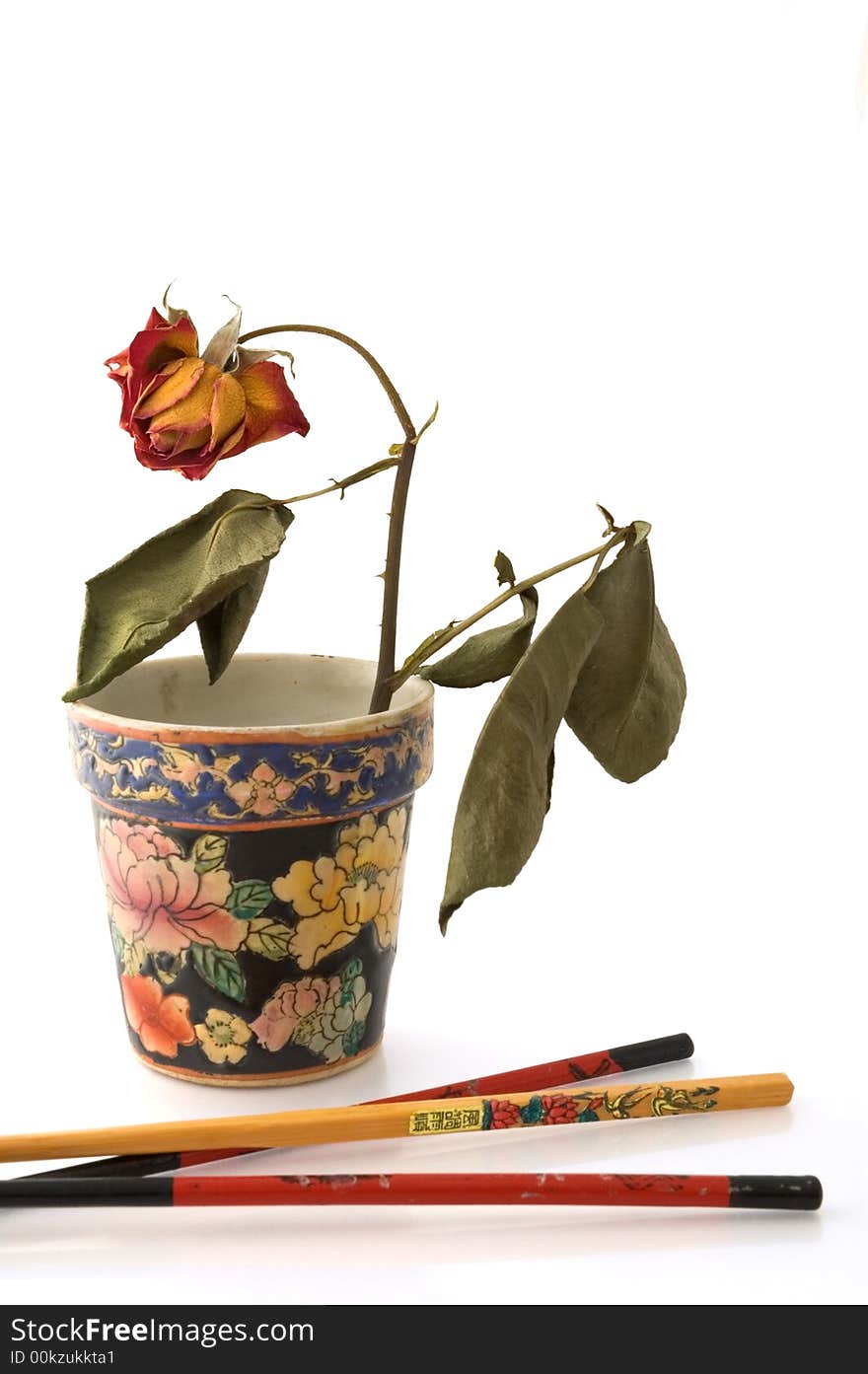 Chopsticks and wilted rose