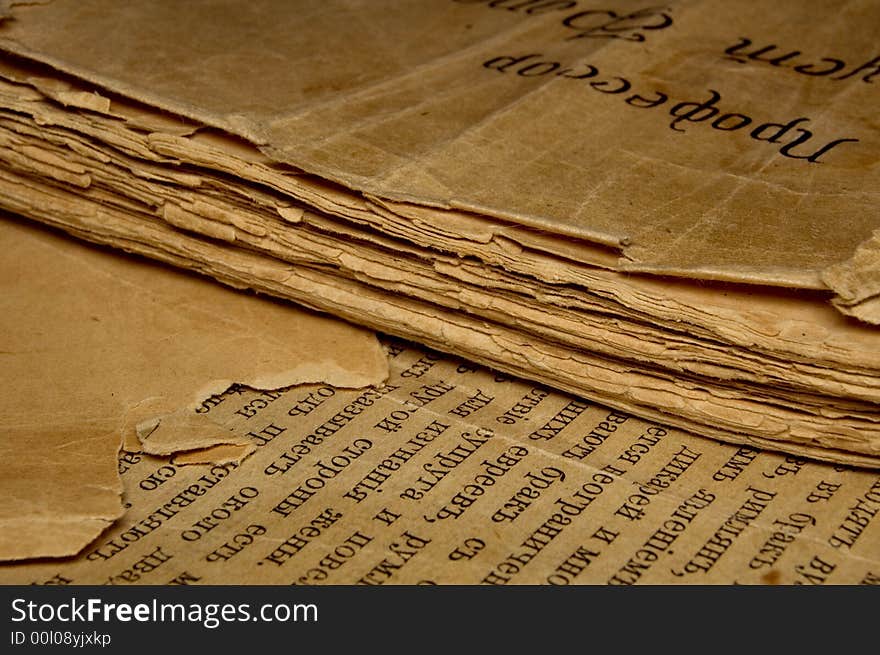 Closeup of an old book with tattered pages and slavonic text