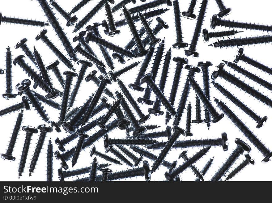 Many Spiral Metal Screws On A White Background