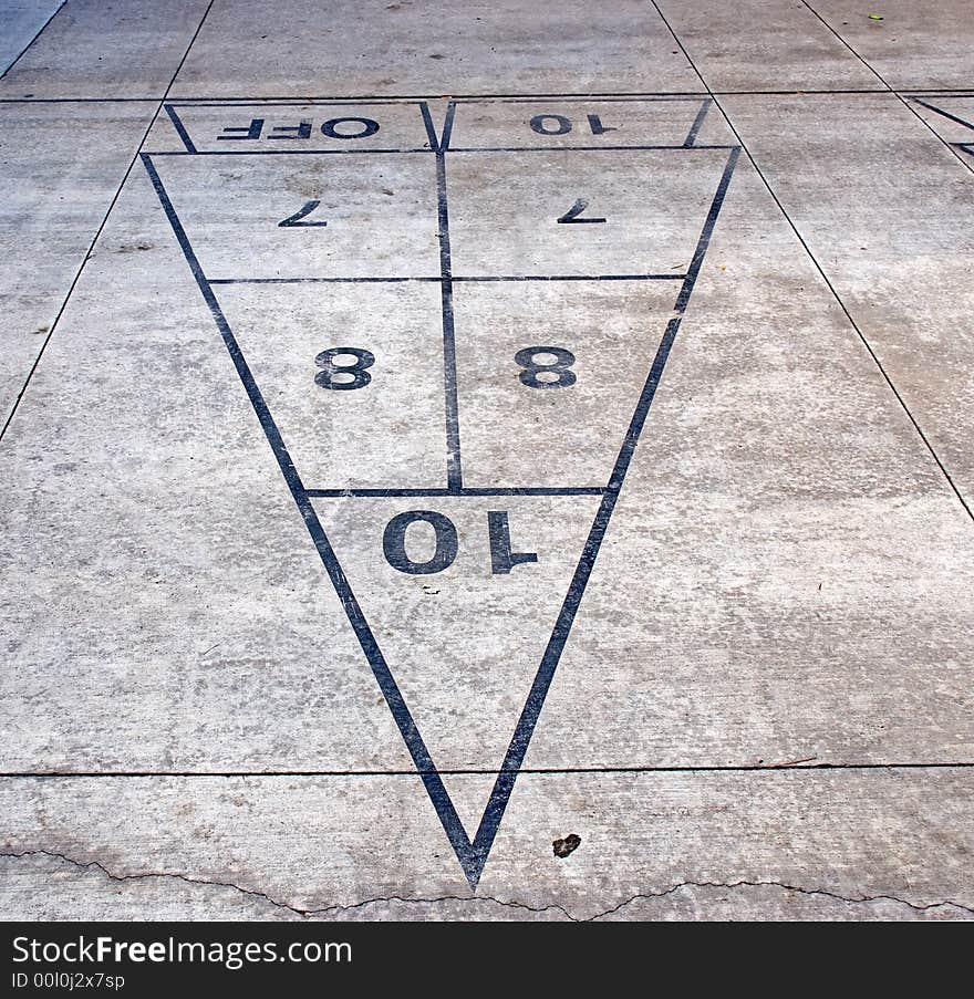 A shuffleboard game outline on a gray sidewalk